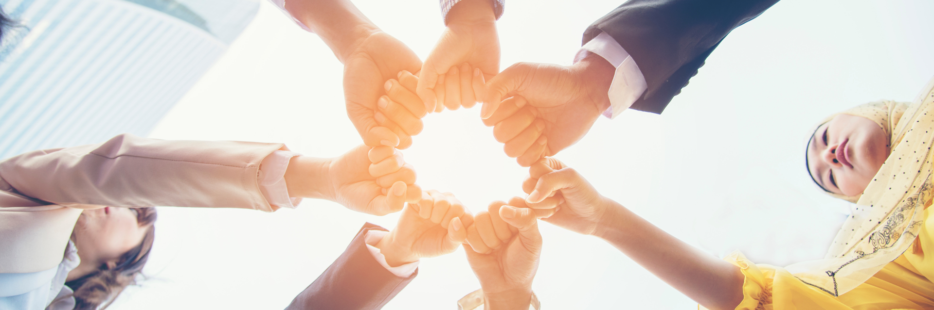 A team with their hands together in the center forming a perfect unity!