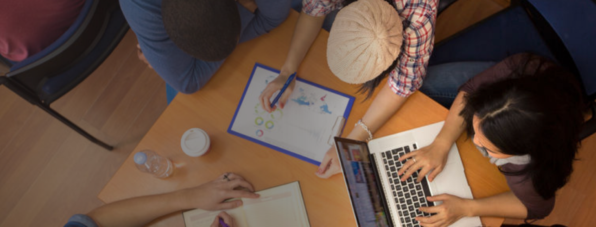 An image of a team working together in a workshiop fashion.